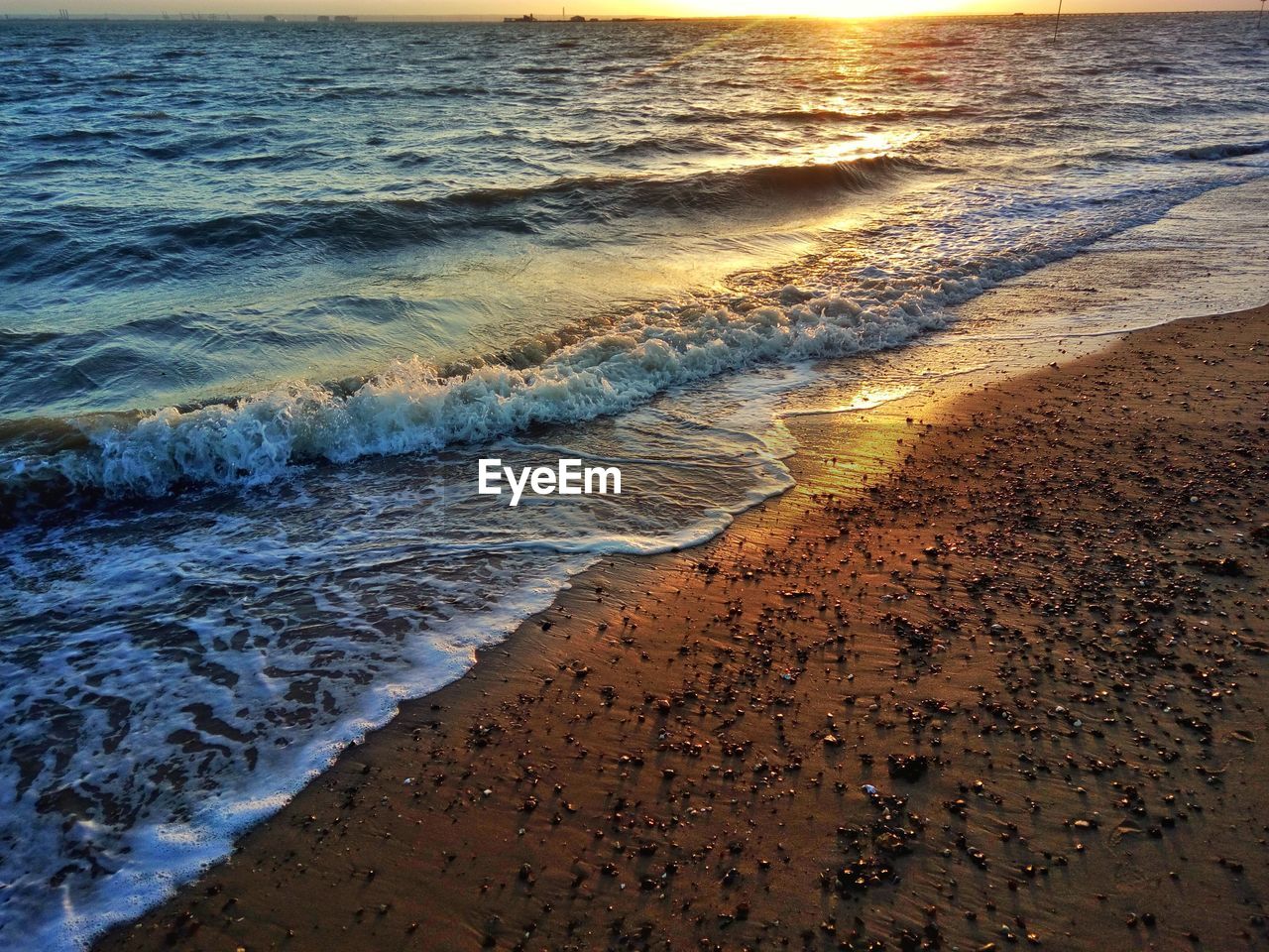 Scenic view of beach against sky during sunset