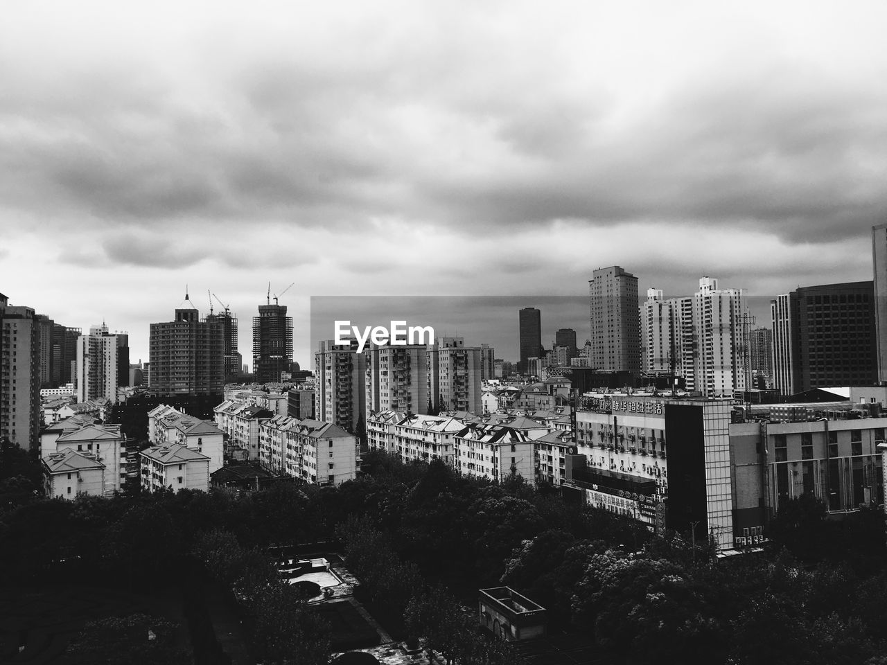 High angle view of cityscape against cloudy sky