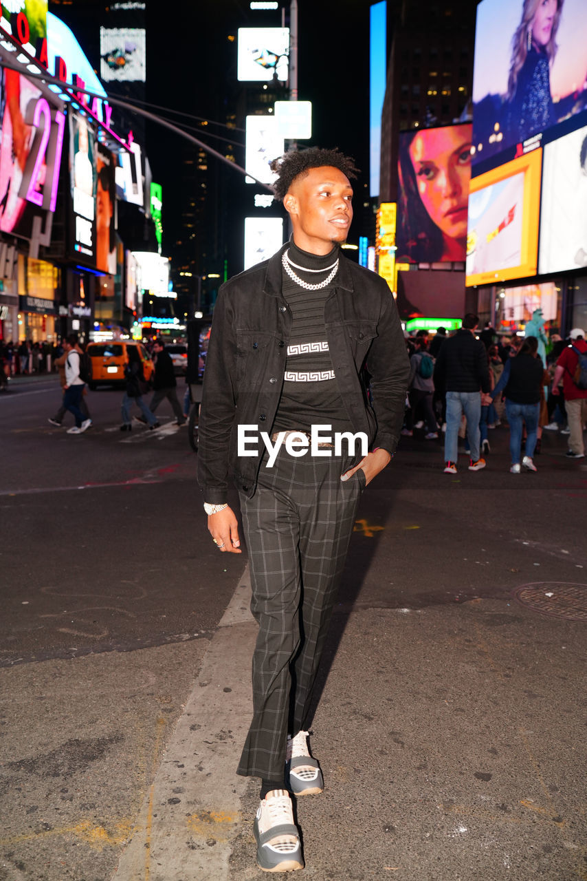 Low section of man standing on street