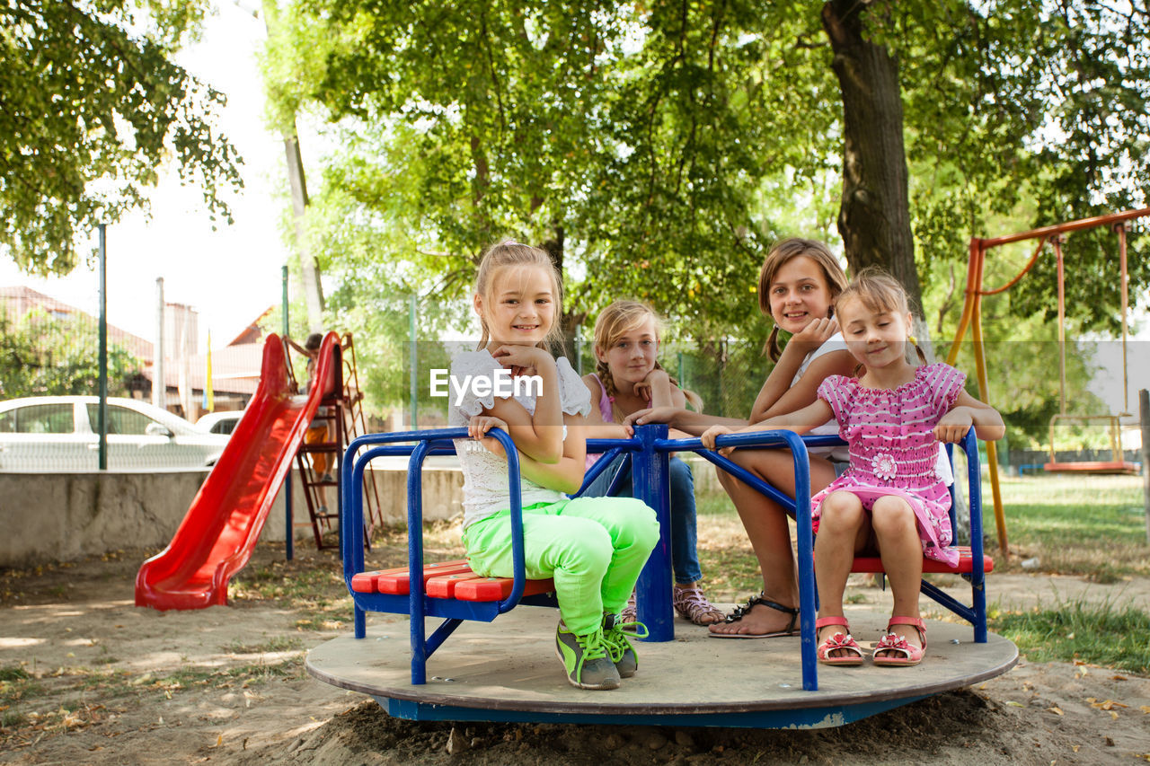 People sitting on slide at playground
