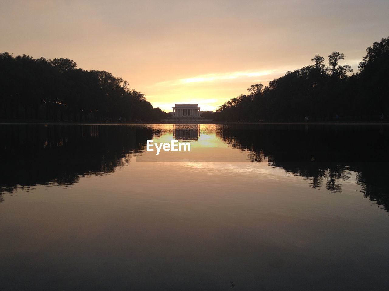 Scenic view of lake against sky during sunset