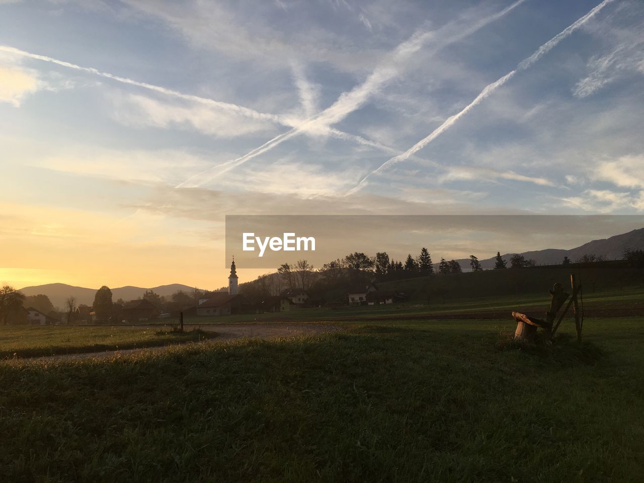 PANORAMIC SHOT OF FIELD AGAINST SKY DURING SUNSET