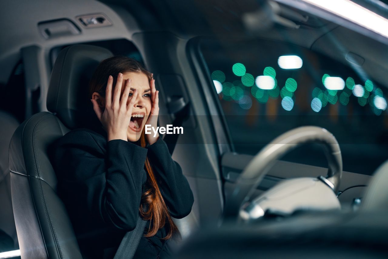 Woman screaming sitting in car
