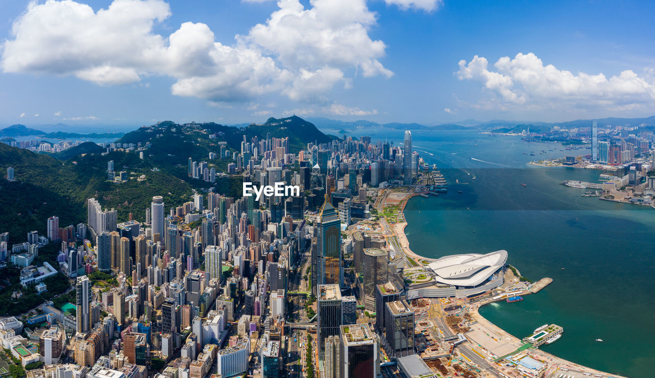 Aerial view of sea and buildings against sky