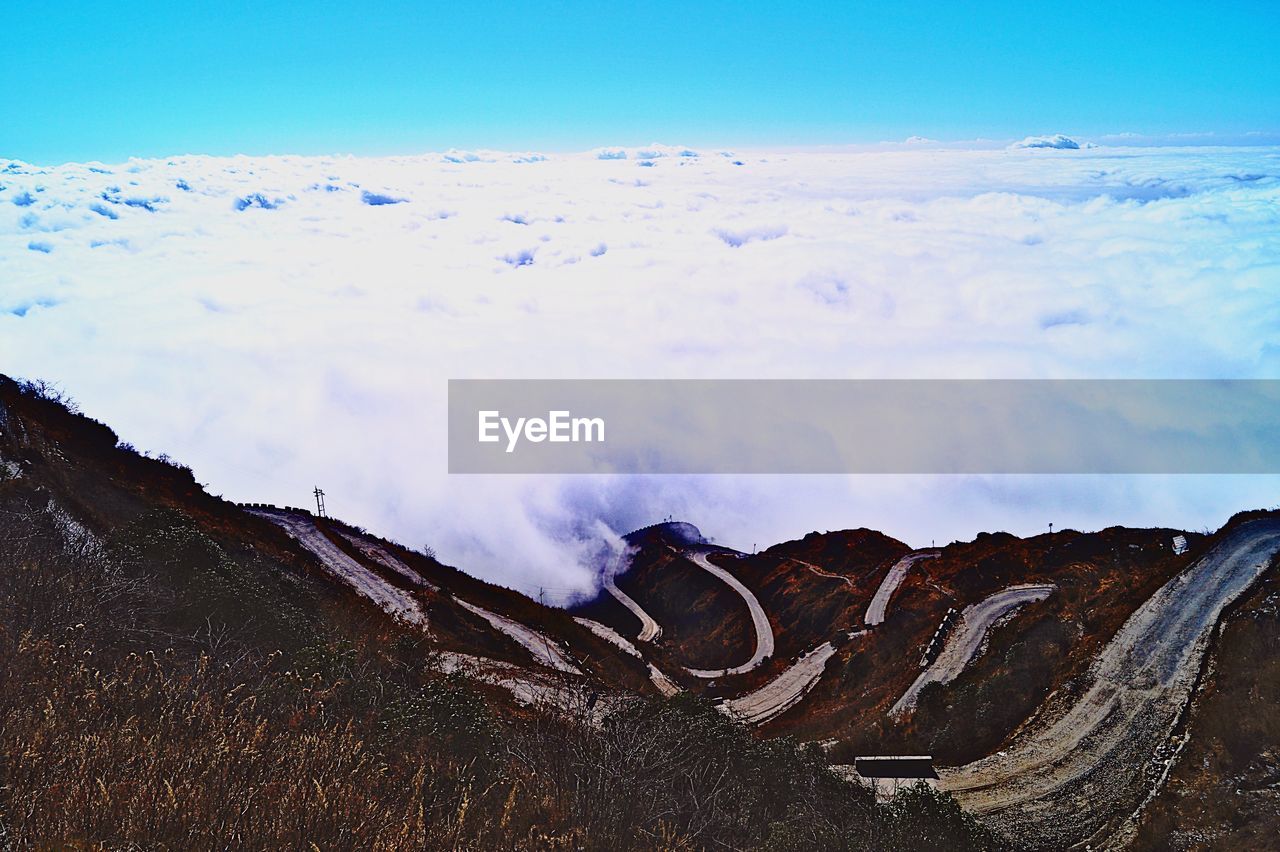 PANORAMIC VIEW OF LAND AND MOUNTAINS AGAINST SKY