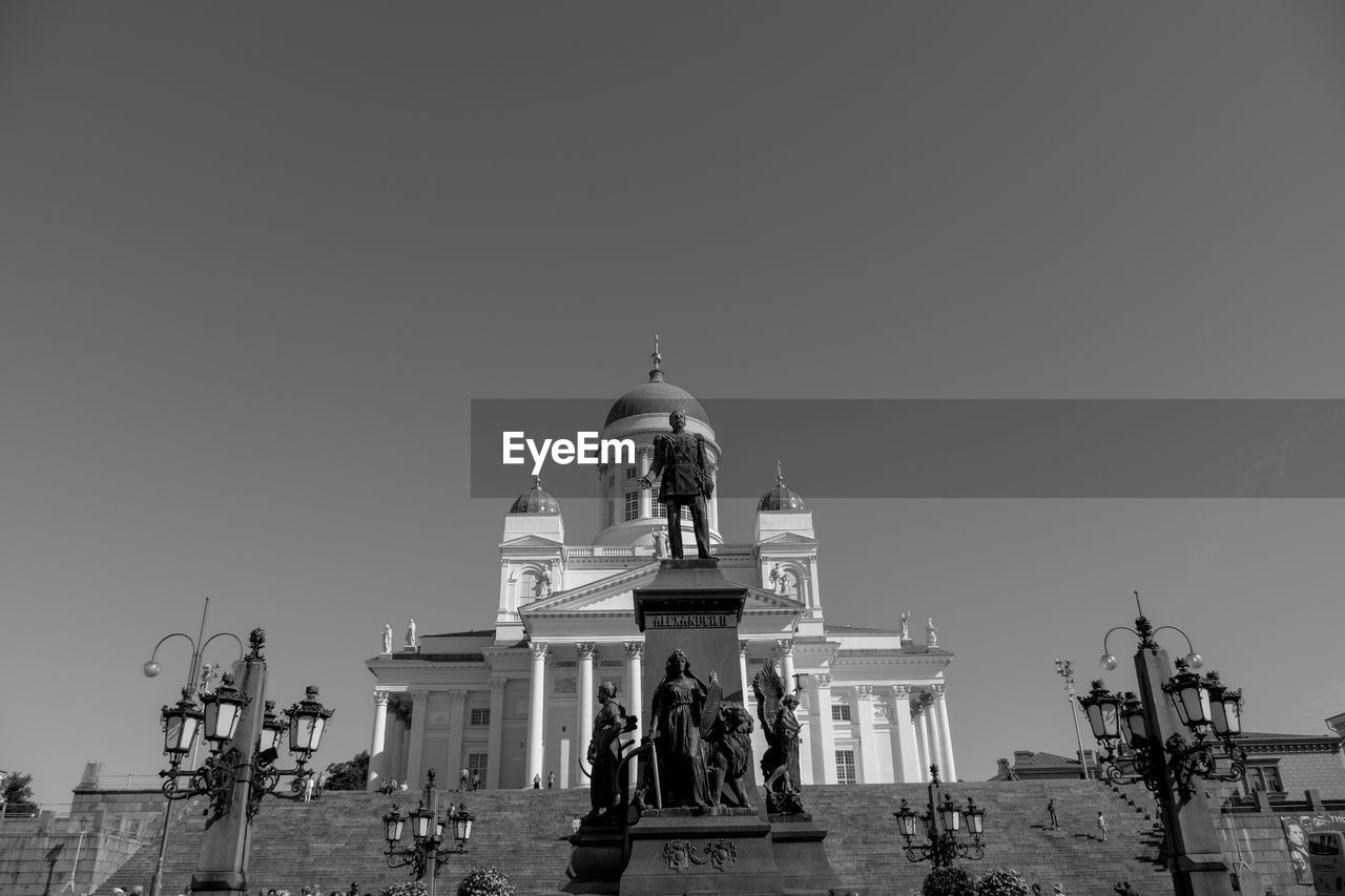 architecture, built structure, sky, building exterior, religion, travel destinations, belief, place of worship, black and white, history, spirituality, clear sky, the past, travel, nature, monochrome, statue, building, sculpture, dome, tourism, group of people, city, monochrome photography, landmark, temple - building, representation, outdoors, human representation, copy space, low angle view, large group of people