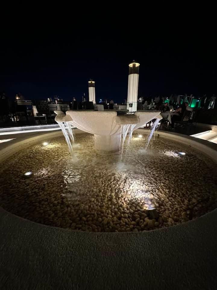 night, lighting, architecture, light, reflection, fountain, water, darkness, water feature, illuminated, city, built structure, building exterior, no people, nature, sky, outdoors, travel destinations, motion