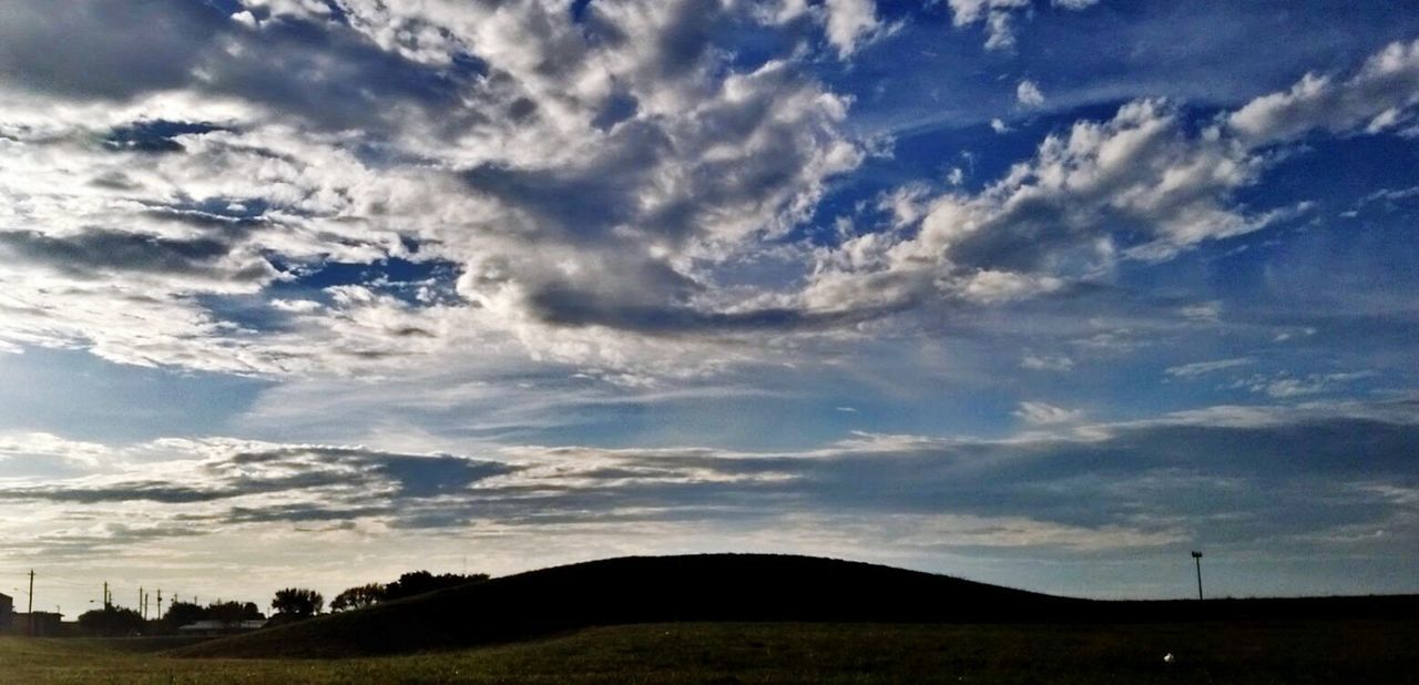 LOW ANGLE VIEW OF SKY OVER LANDSCAPE AGAINST CLOUDY BLUE