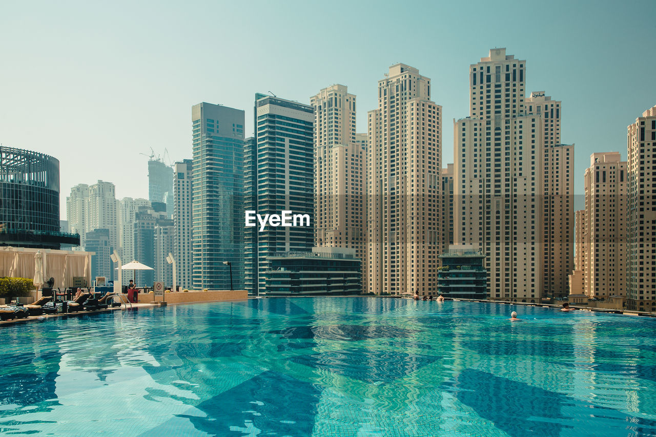 Dubai city in the uae. dubai marina. modern buildings by swimming pool in city