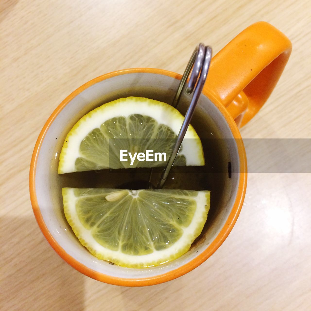 Close-up of sliced lemons in cup on table