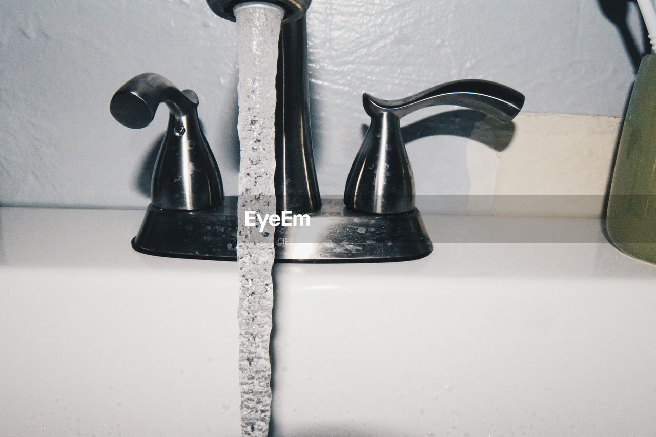 Close-up of water flowing from faucet