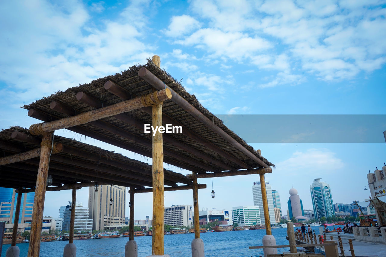 GAZEBO ON BEACH AGAINST SKY IN CITY