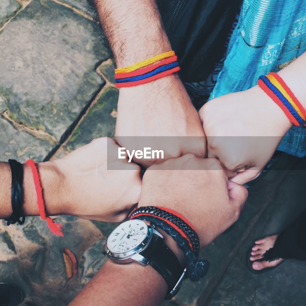 Cropped image of friends wearing bracelets