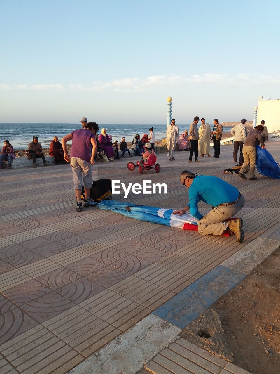 PEOPLE ON BEACH AGAINST SKY