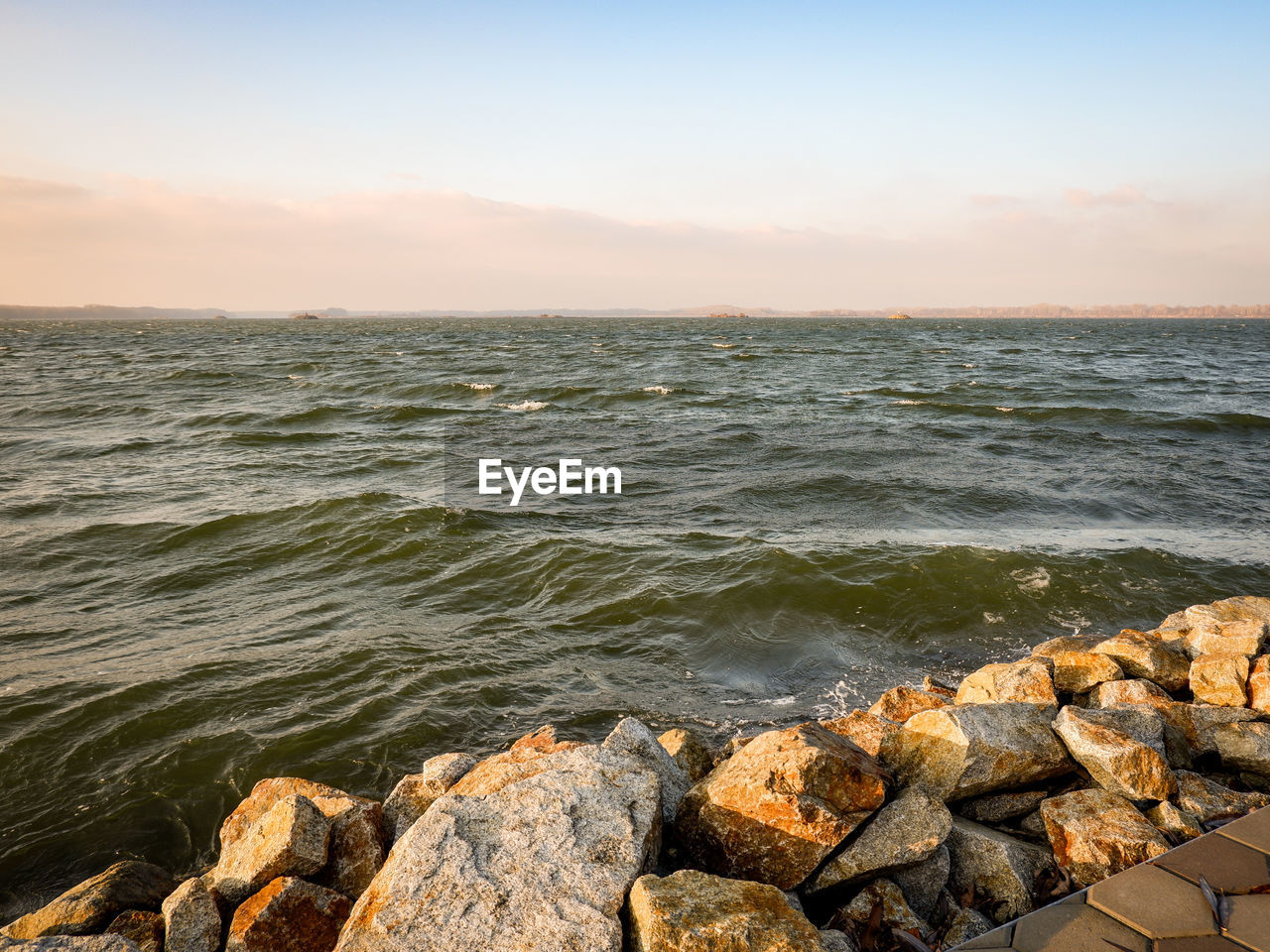water, sea, rock, sky, shore, body of water, land, horizon, nature, scenics - nature, beauty in nature, ocean, beach, coast, sunset, wave, tranquility, horizon over water, environment, motion, no people, tranquil scene, sunlight, outdoors, landscape, seascape, travel, travel destinations, idyllic, stone, sun, clear sky, dusk, day, wind wave, cloud, coastline, sand, terrain, bay, architecture, sports, cliff