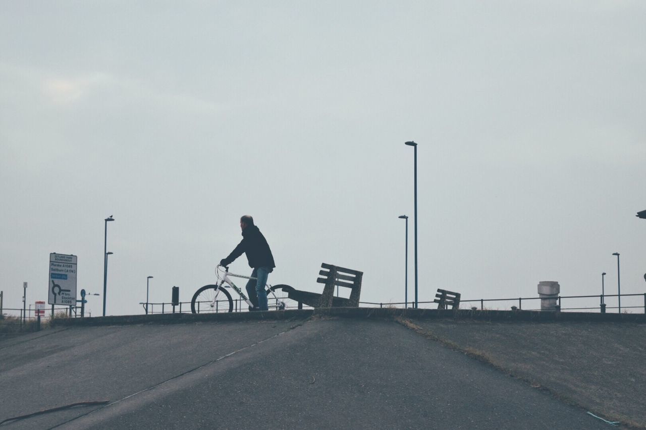 SILHOUETTE OF MAN ON STREET