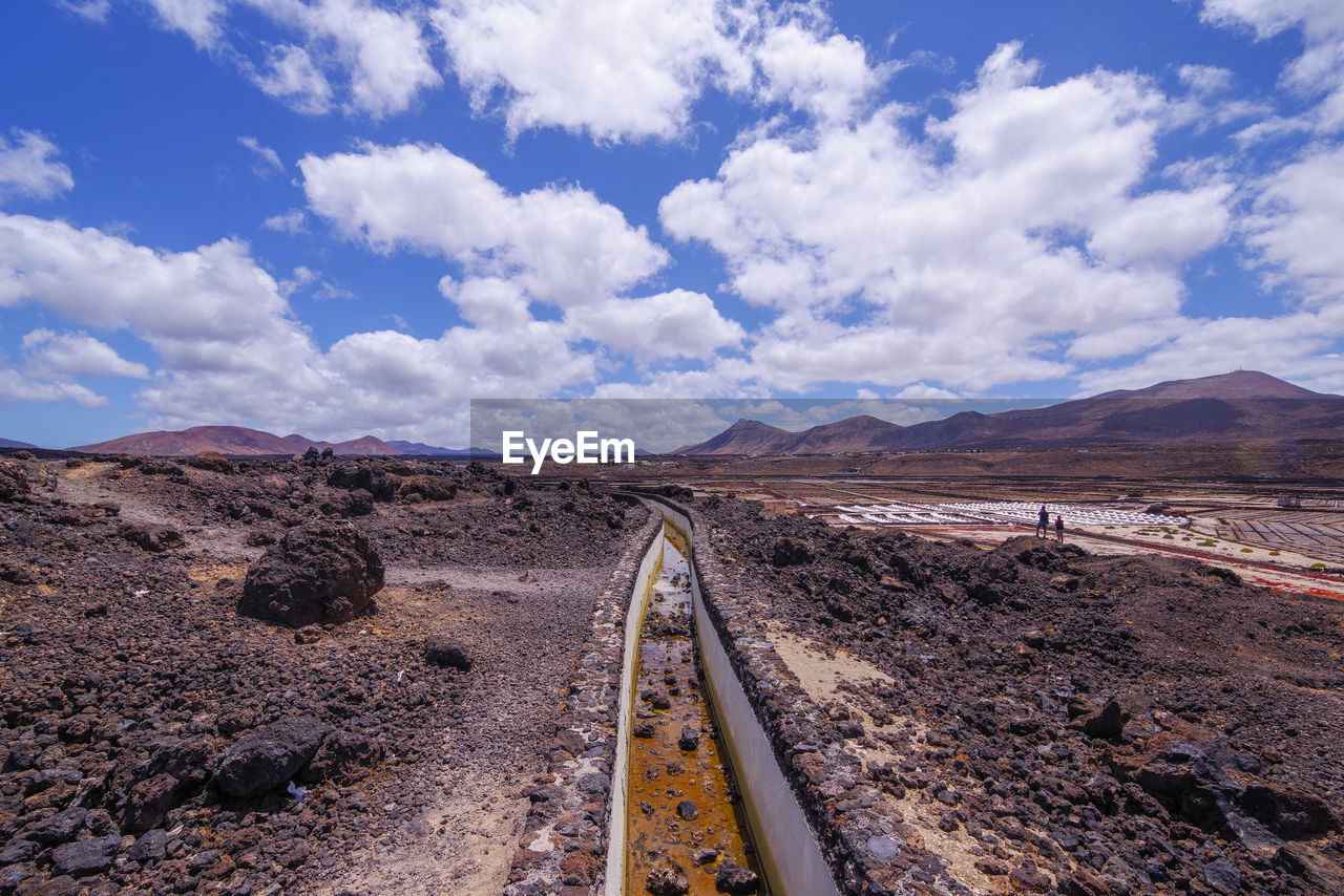 RAILROAD TRACKS LEADING TOWARDS MOUNTAINS