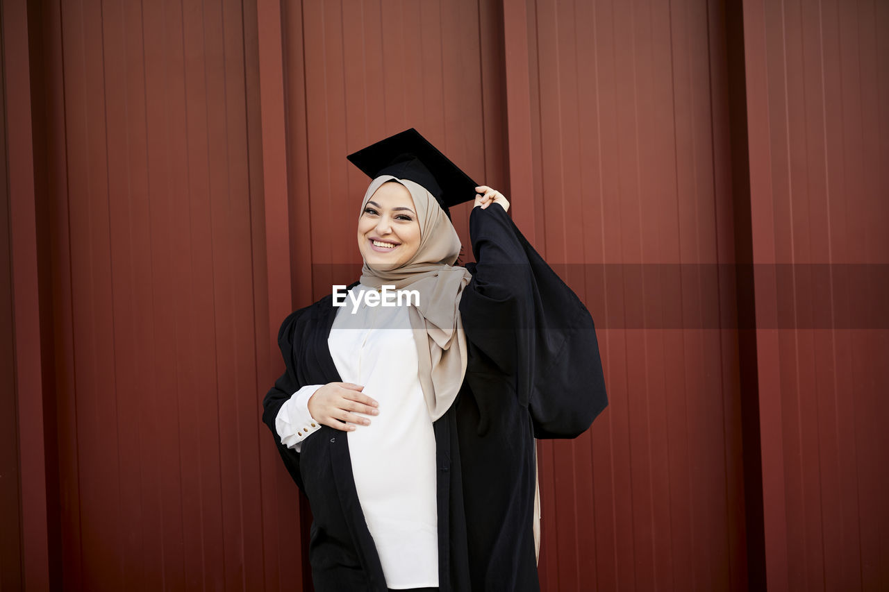 Smiling woman wearing graduation hat