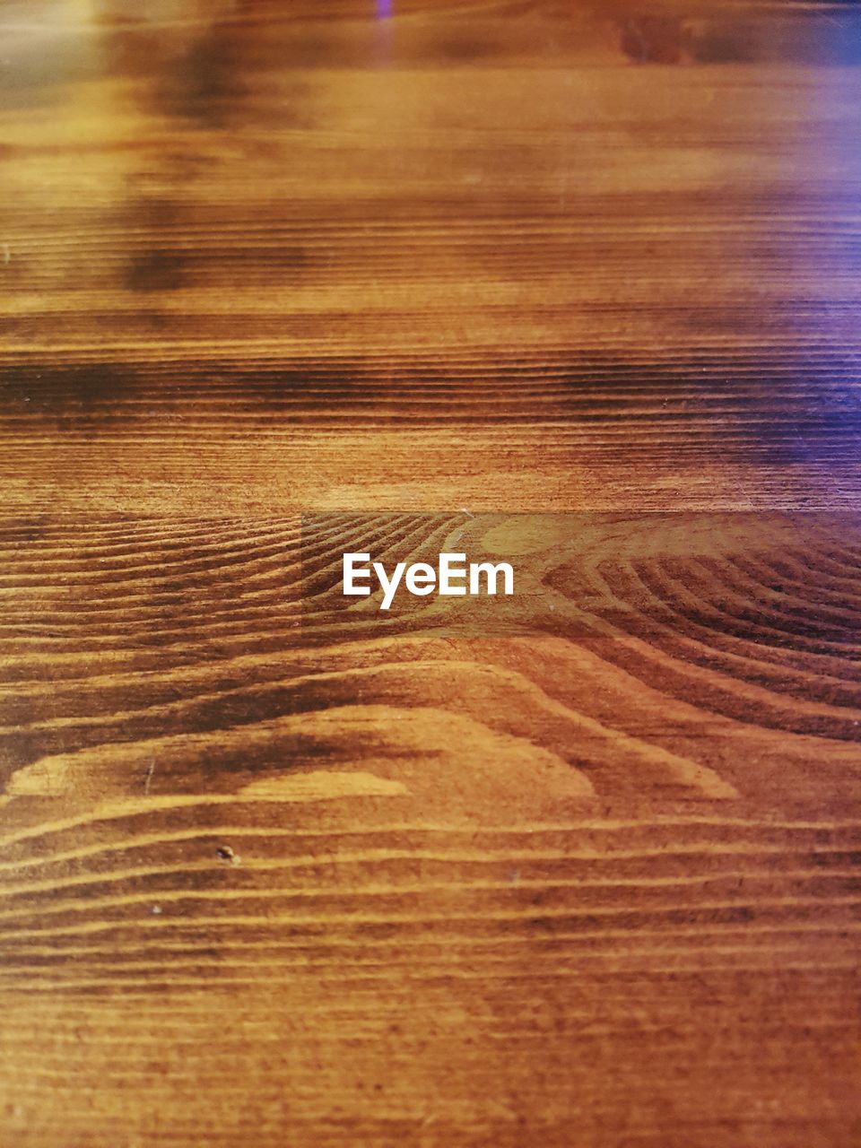 CLOSE-UP OF WOOD ON HARDWOOD FLOOR AGAINST SUNLIGHT