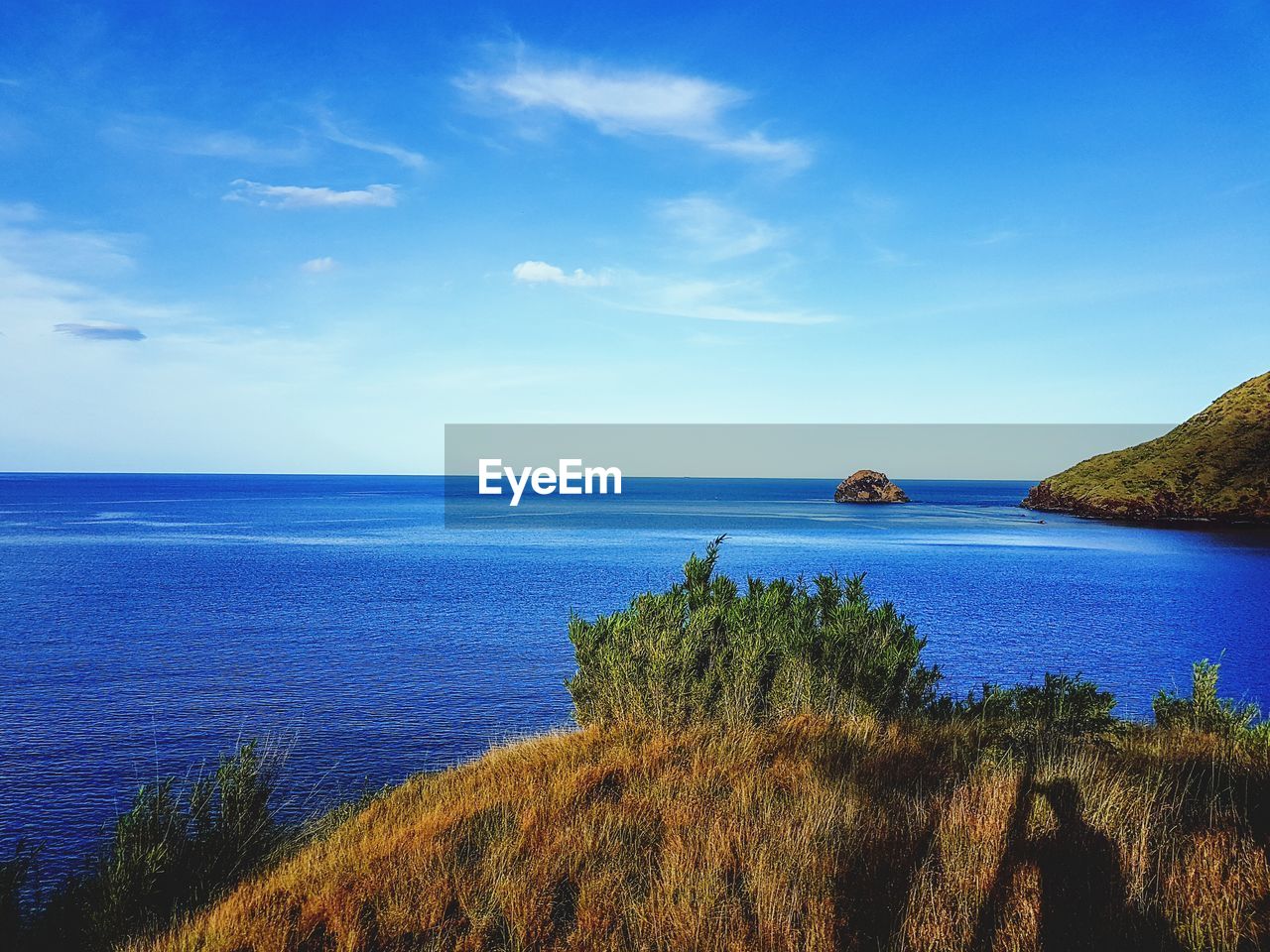 Scenic view of sea against blue sky