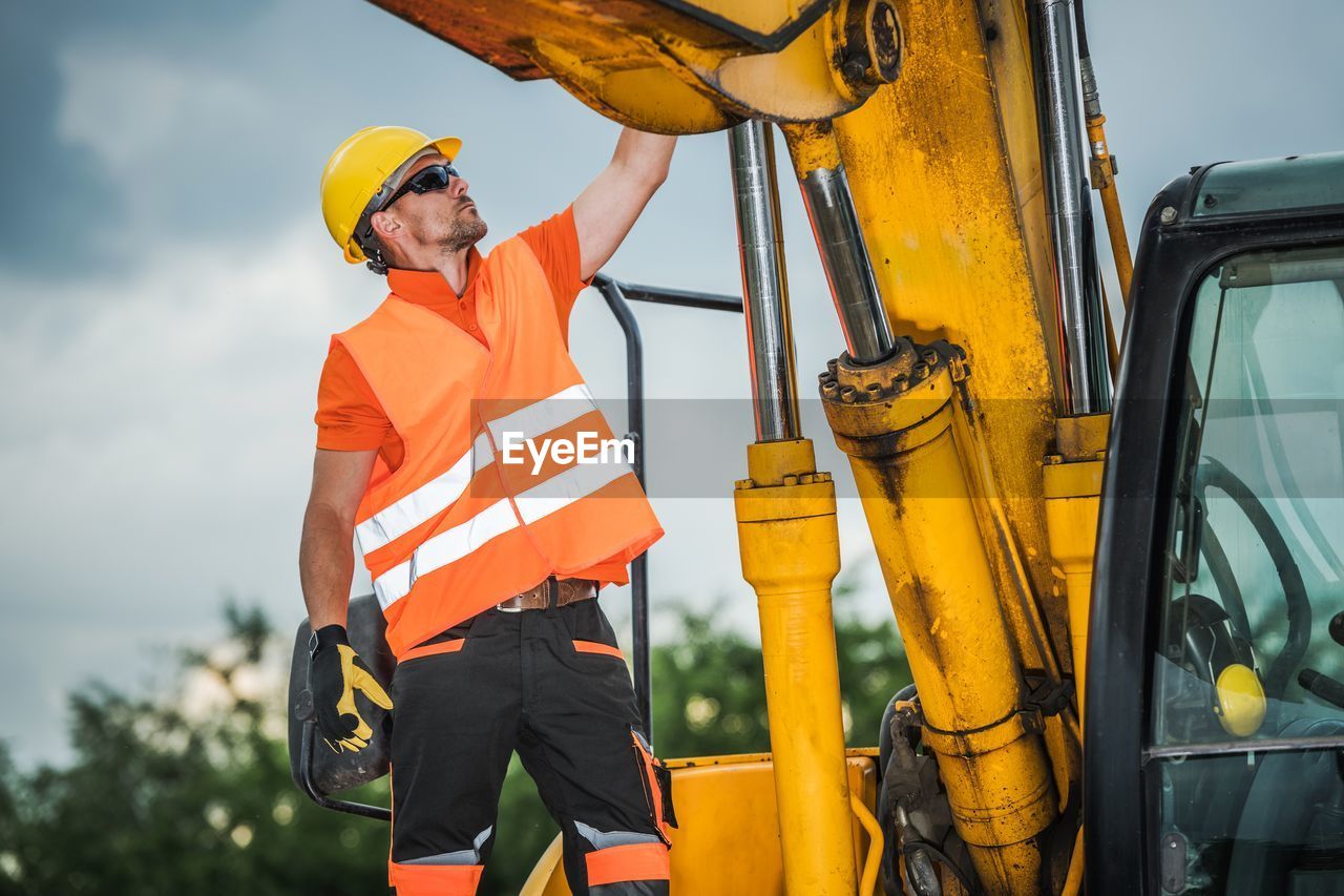 Worker standing by earth mover
