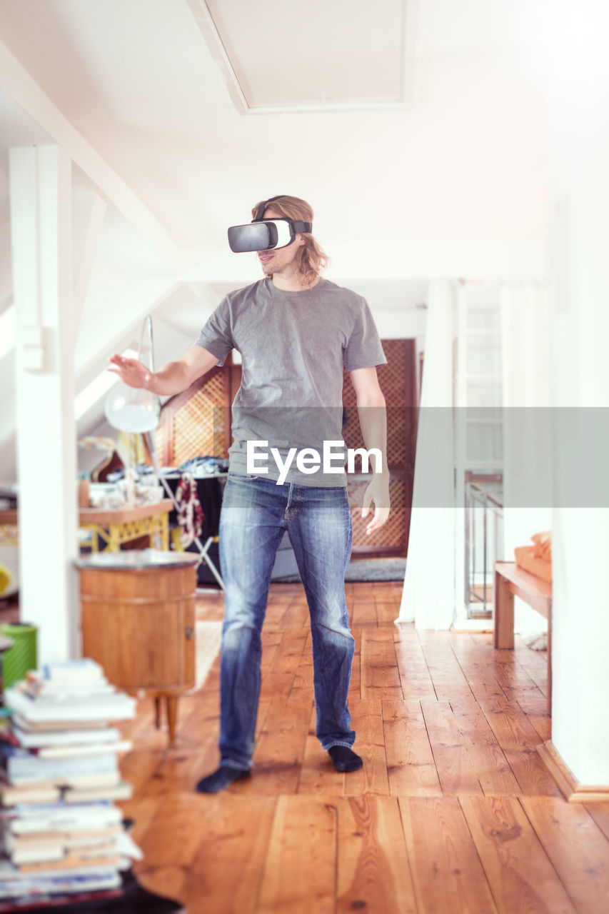 YOUNG MAN STANDING AT HOME