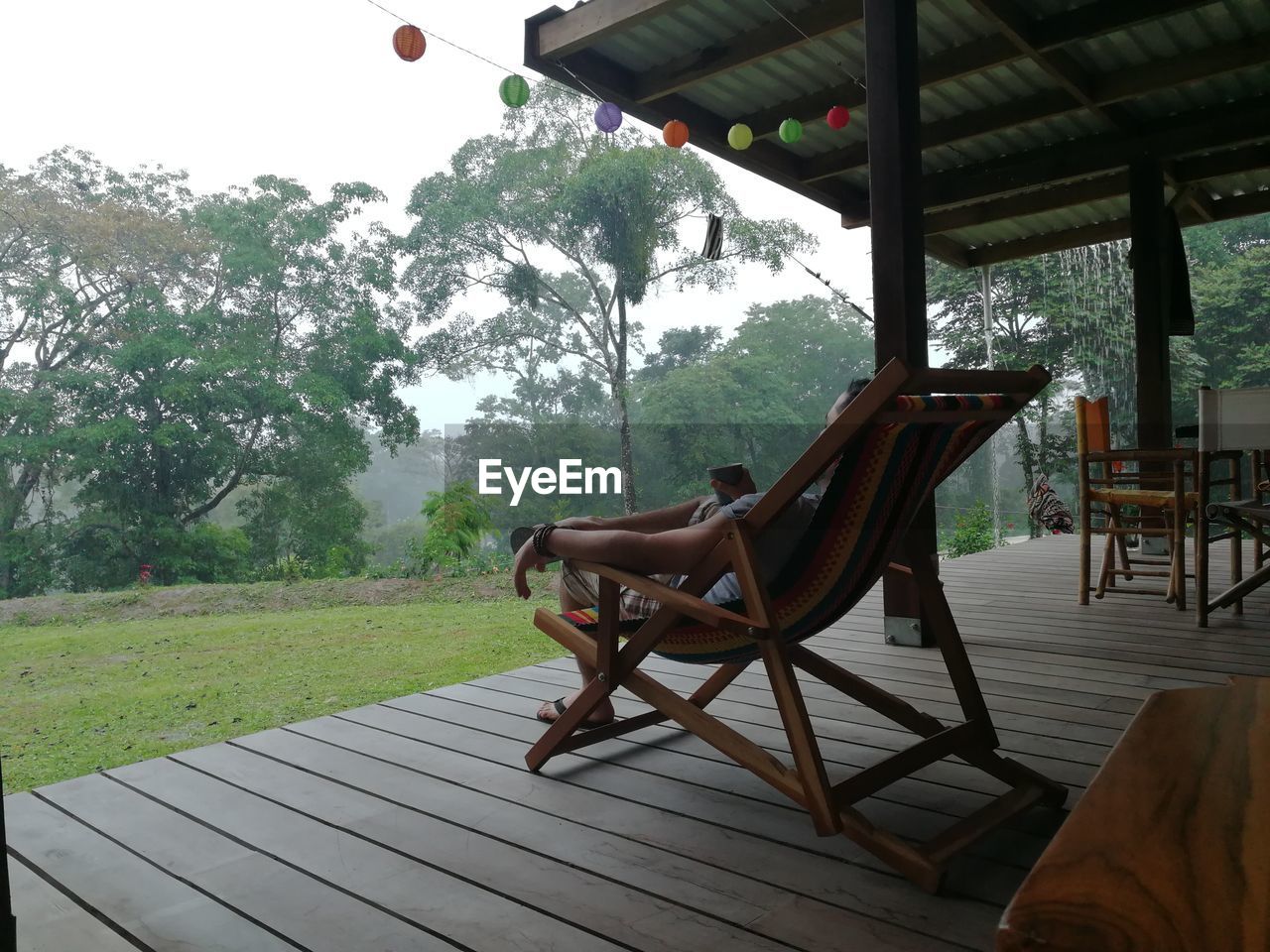 Man relaxing on chair in porch