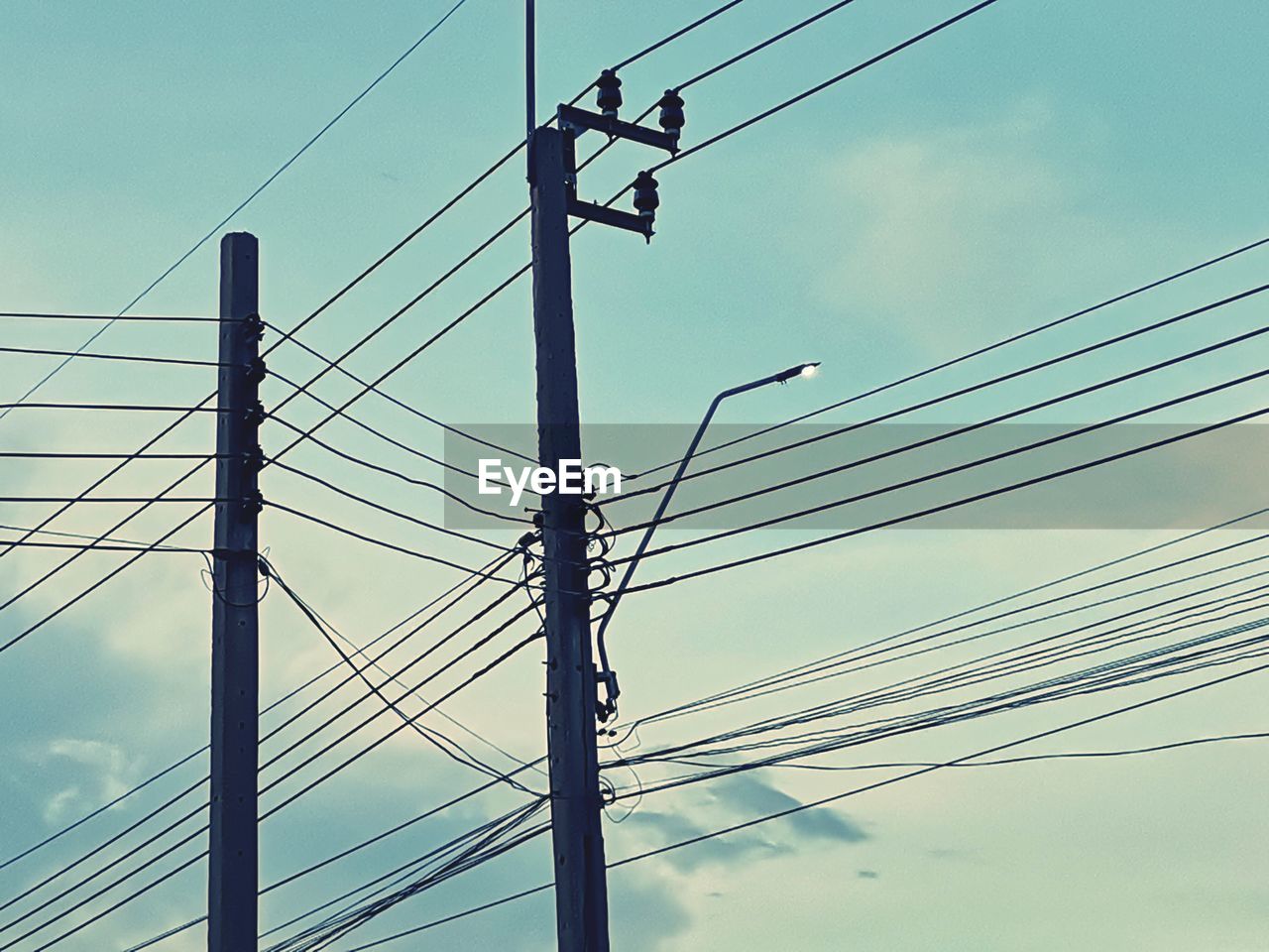 Low angle view of electricity pylon against sky