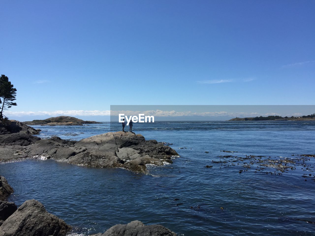 Rock formations by sea against sky