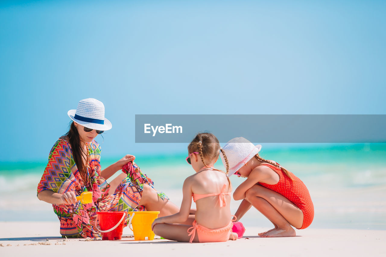 WOMEN SITTING ON BEACH