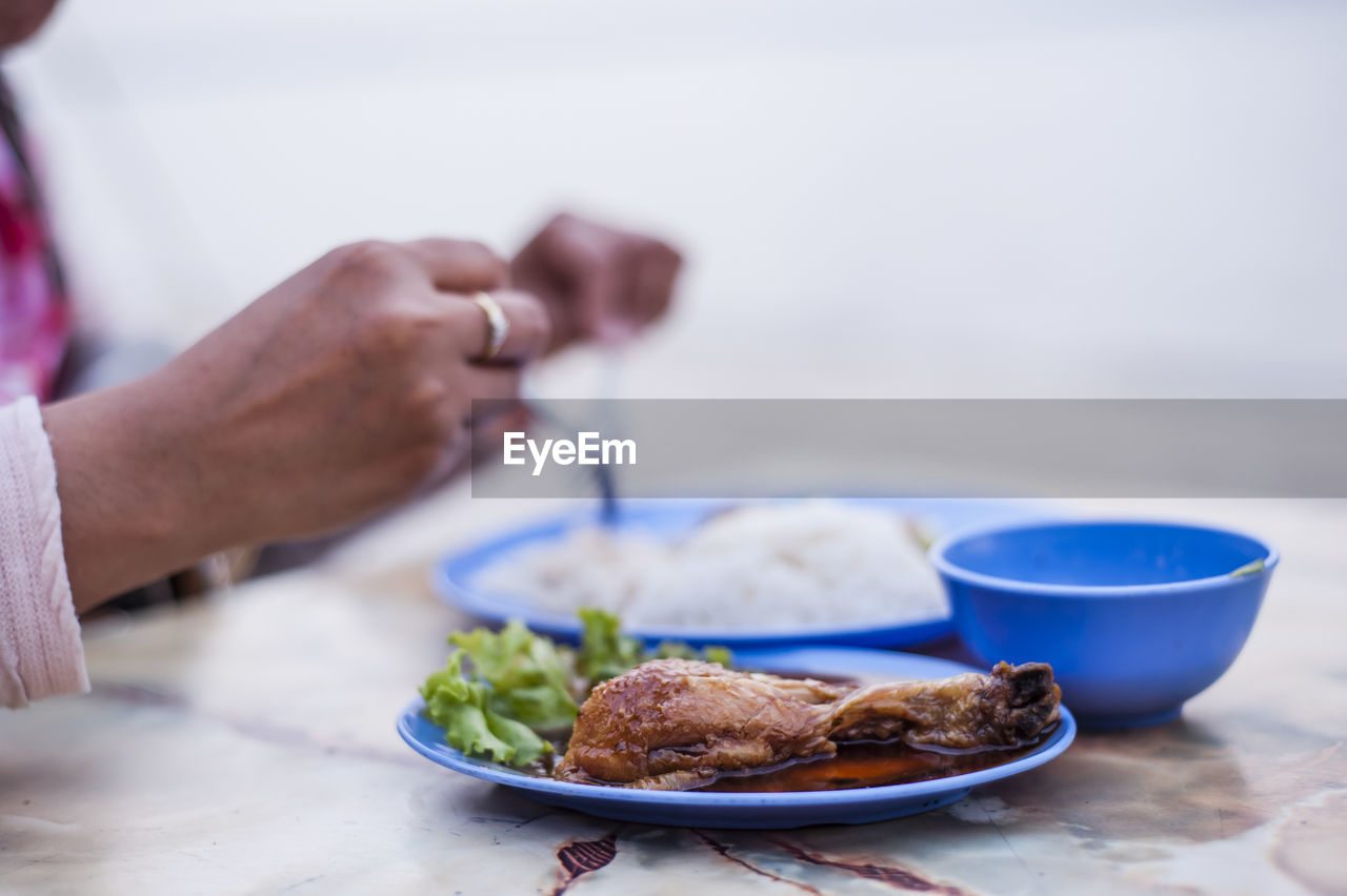 Cropped image of person having food