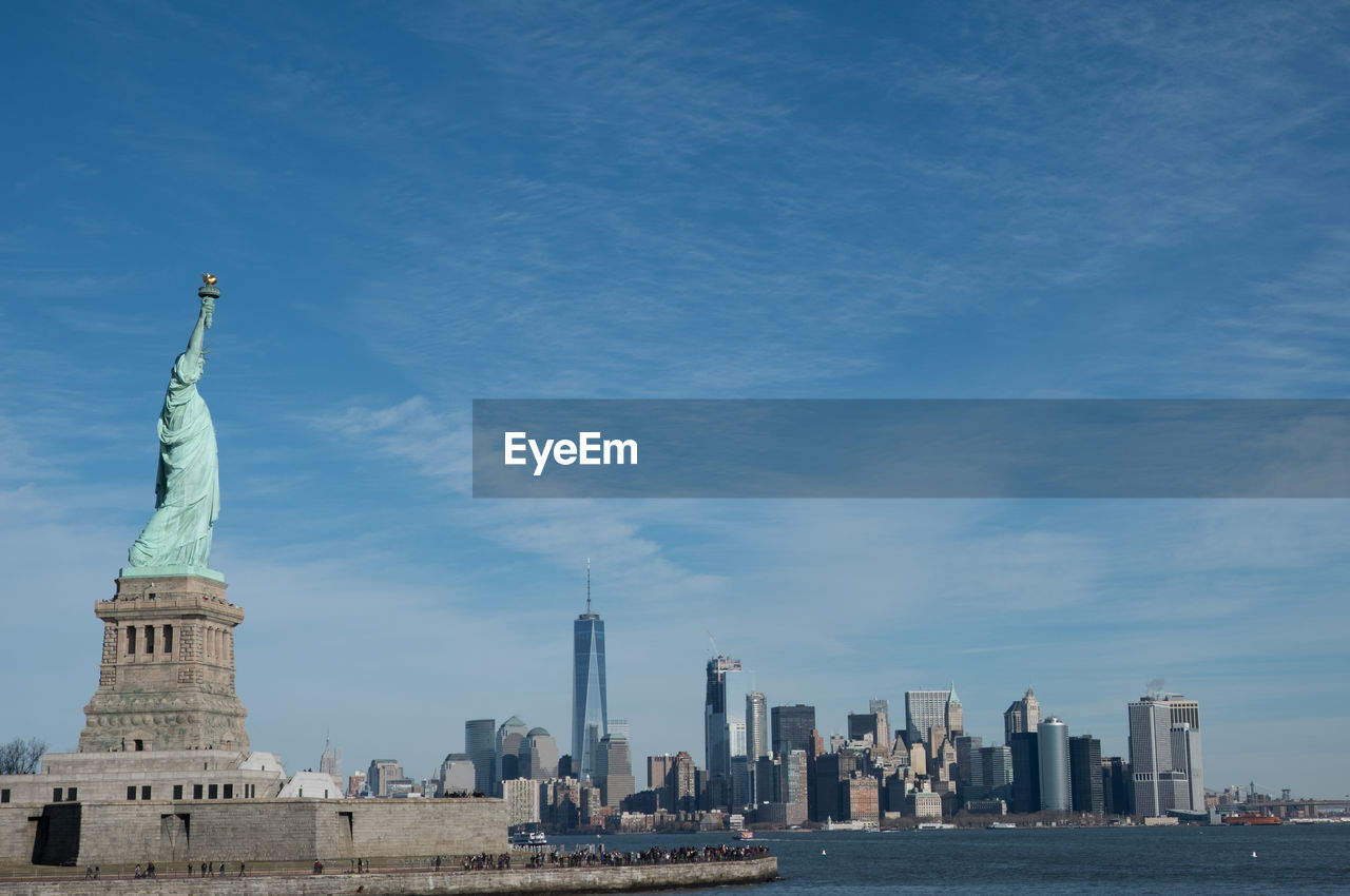 Statue of liberty against sky in city