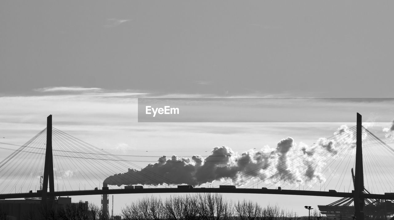 Cable-stayed bridge against cloudy sky