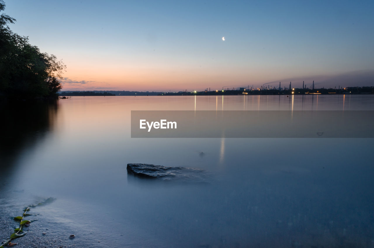 Scenic view of lake against sky during sunset