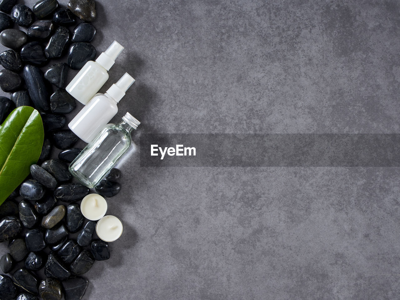 HIGH ANGLE VIEW OF BOTTLES ON TABLE AGAINST WHITE BACKGROUND