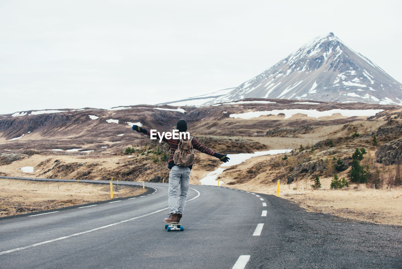 Man skateboarding on highway