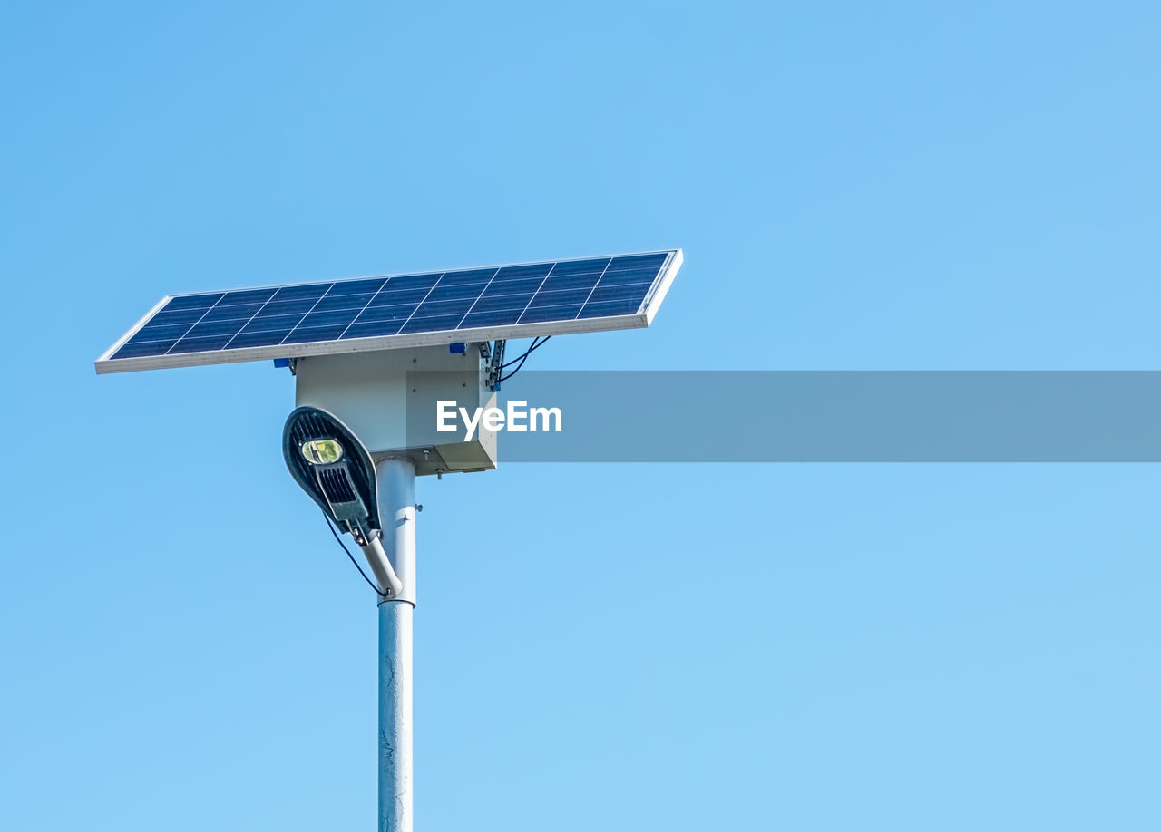 Low angle view of solar panel against clear blue sky