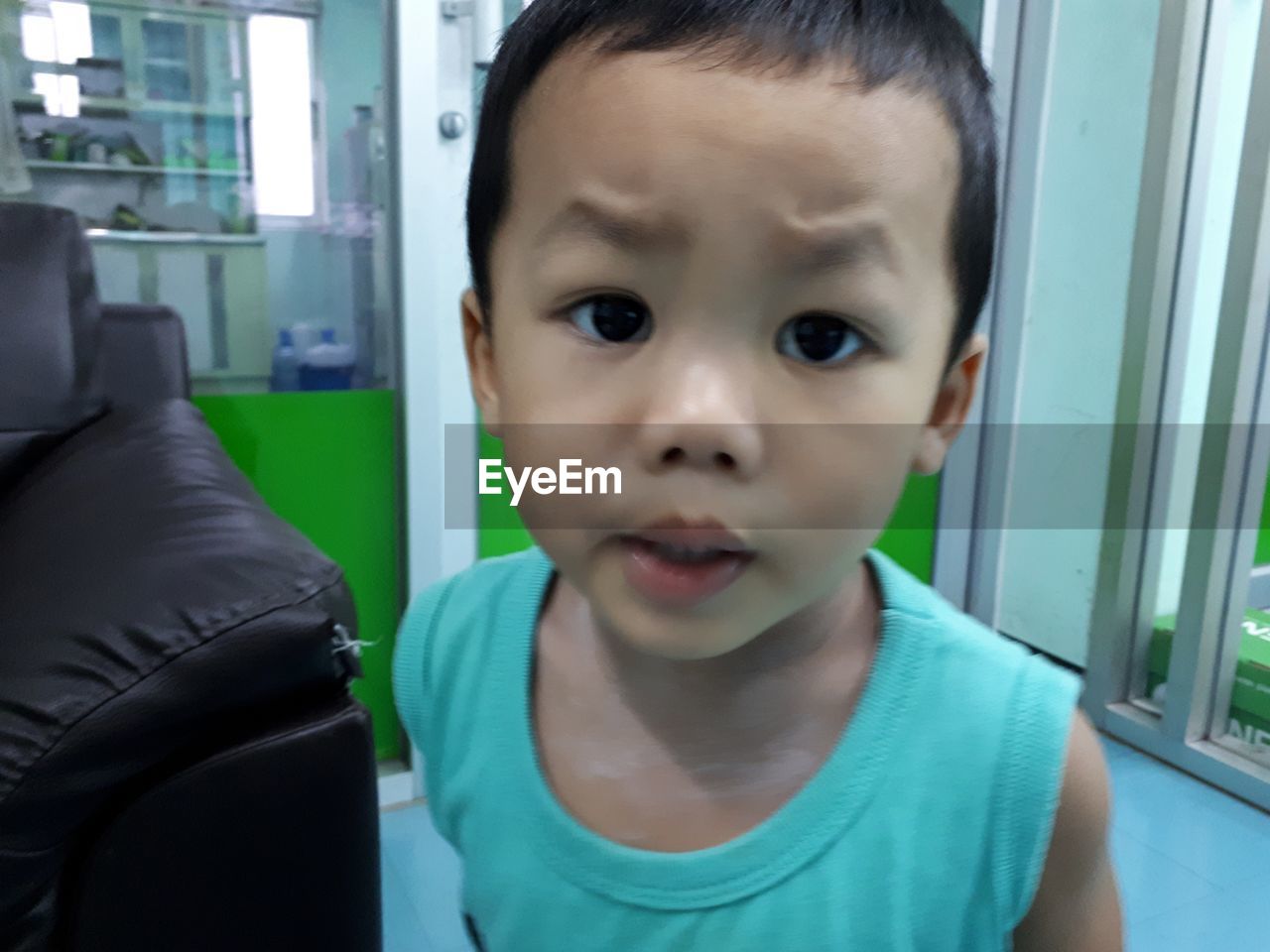 CLOSE-UP PORTRAIT OF BOY AT HOME