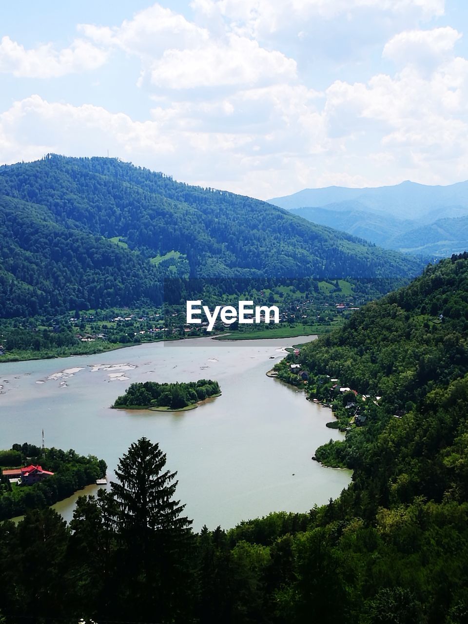 SCENIC VIEW OF TREES AND MOUNTAINS AGAINST SKY