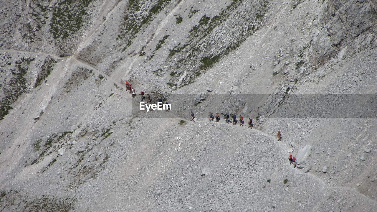 High angle view of people hiking on mountain