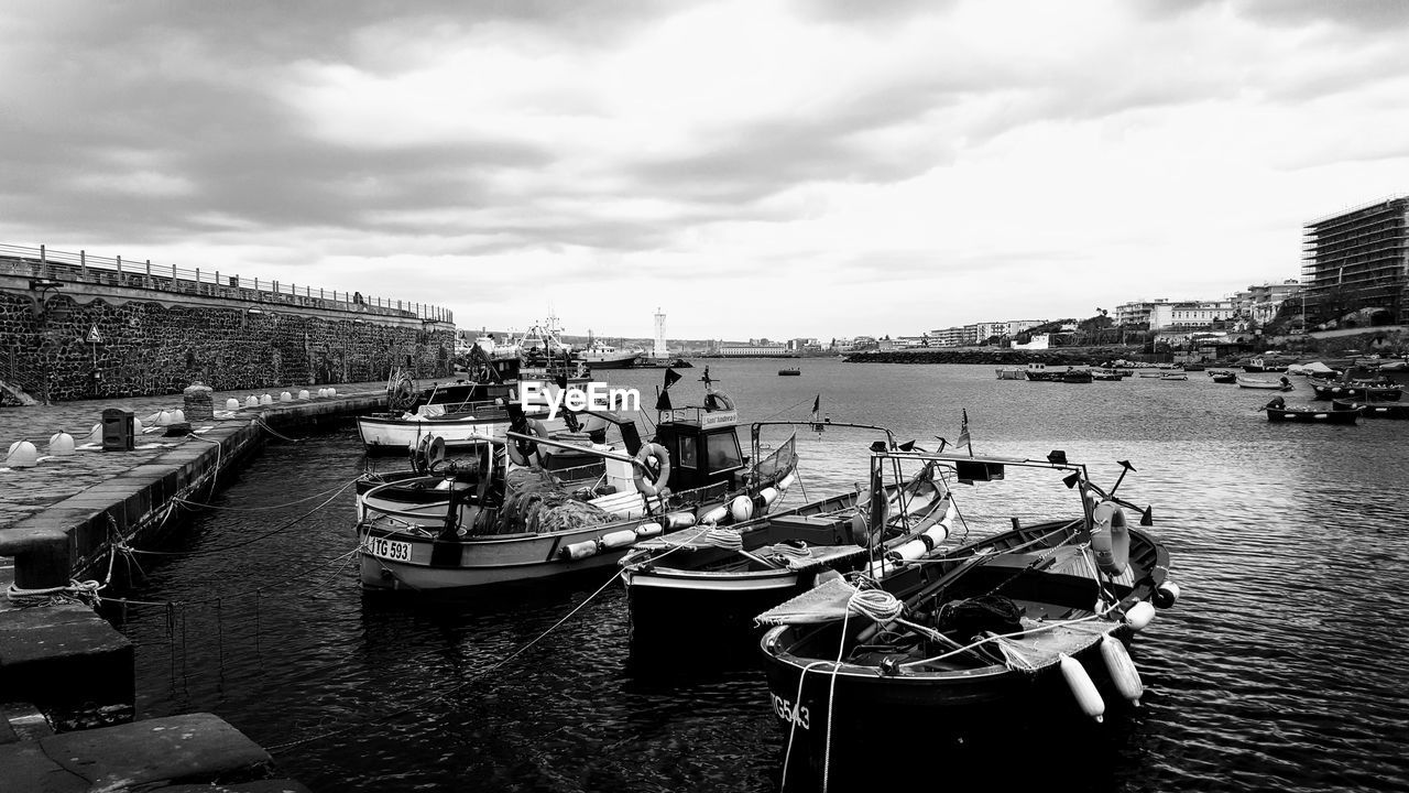 SAILBOATS MOORED IN MARINA