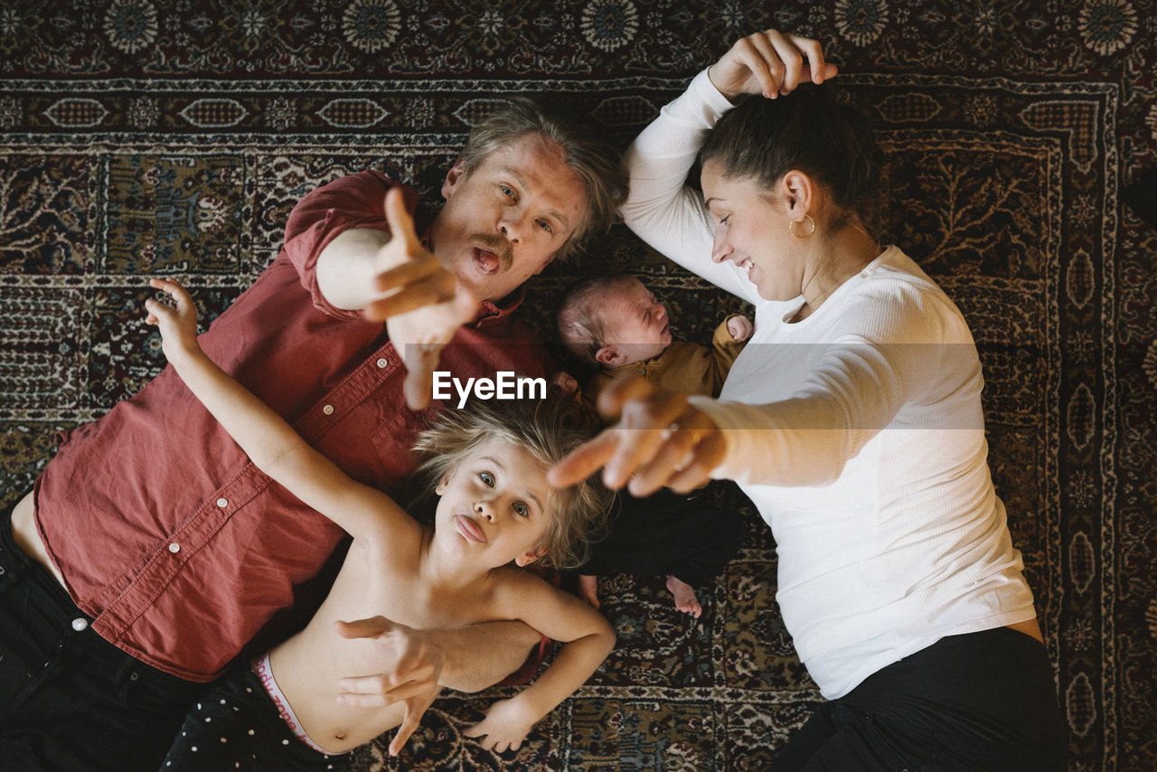 Parents with two children looking at camera