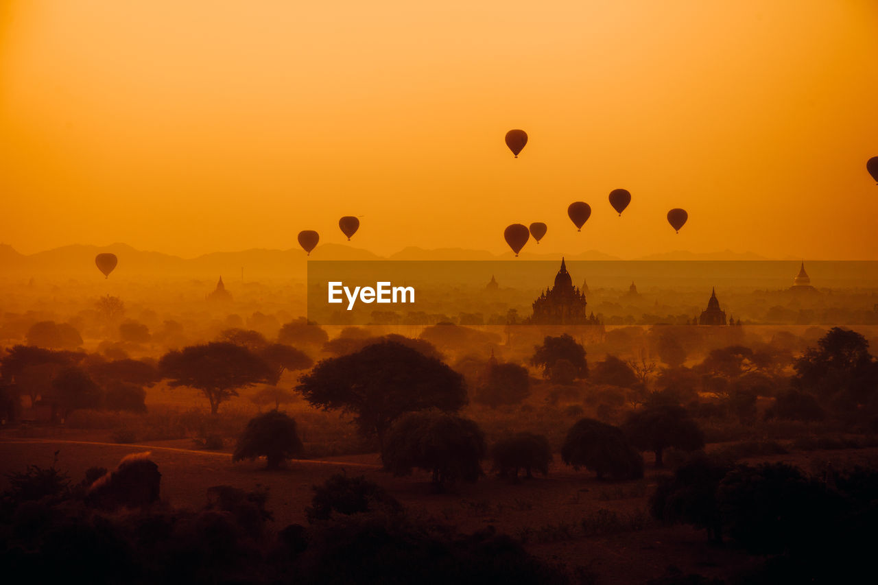 VIEW OF HOT AIR BALLOONS IN SKY DURING SUNSET