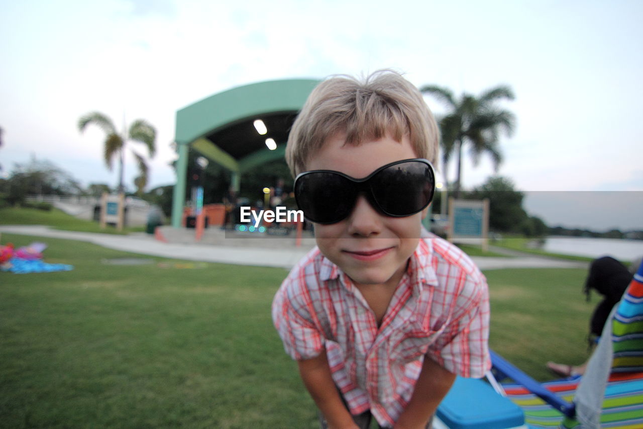 Boy wearing sunglasses on field