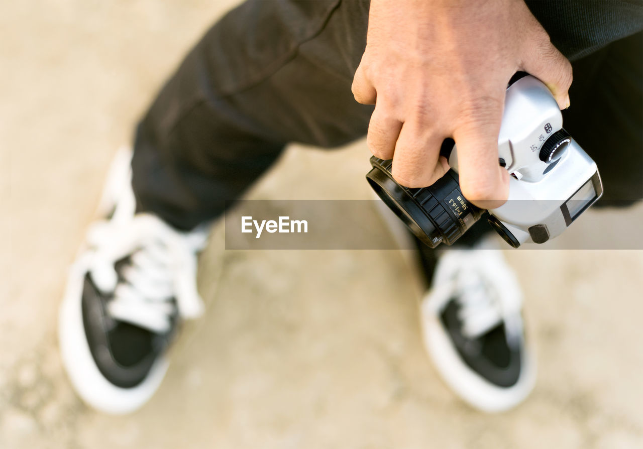 LOW SECTION OF MAN HOLDING SMART