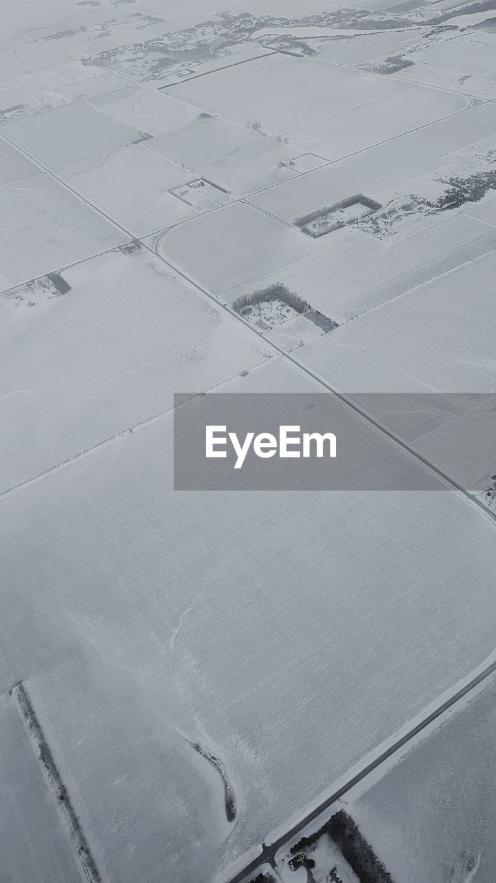 HIGH ANGLE VIEW OF SNOW ON FIELD