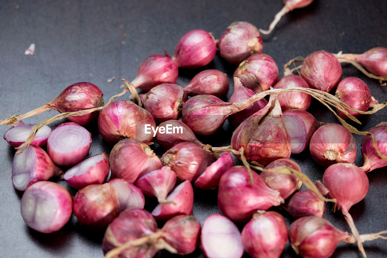 Red onions on black table