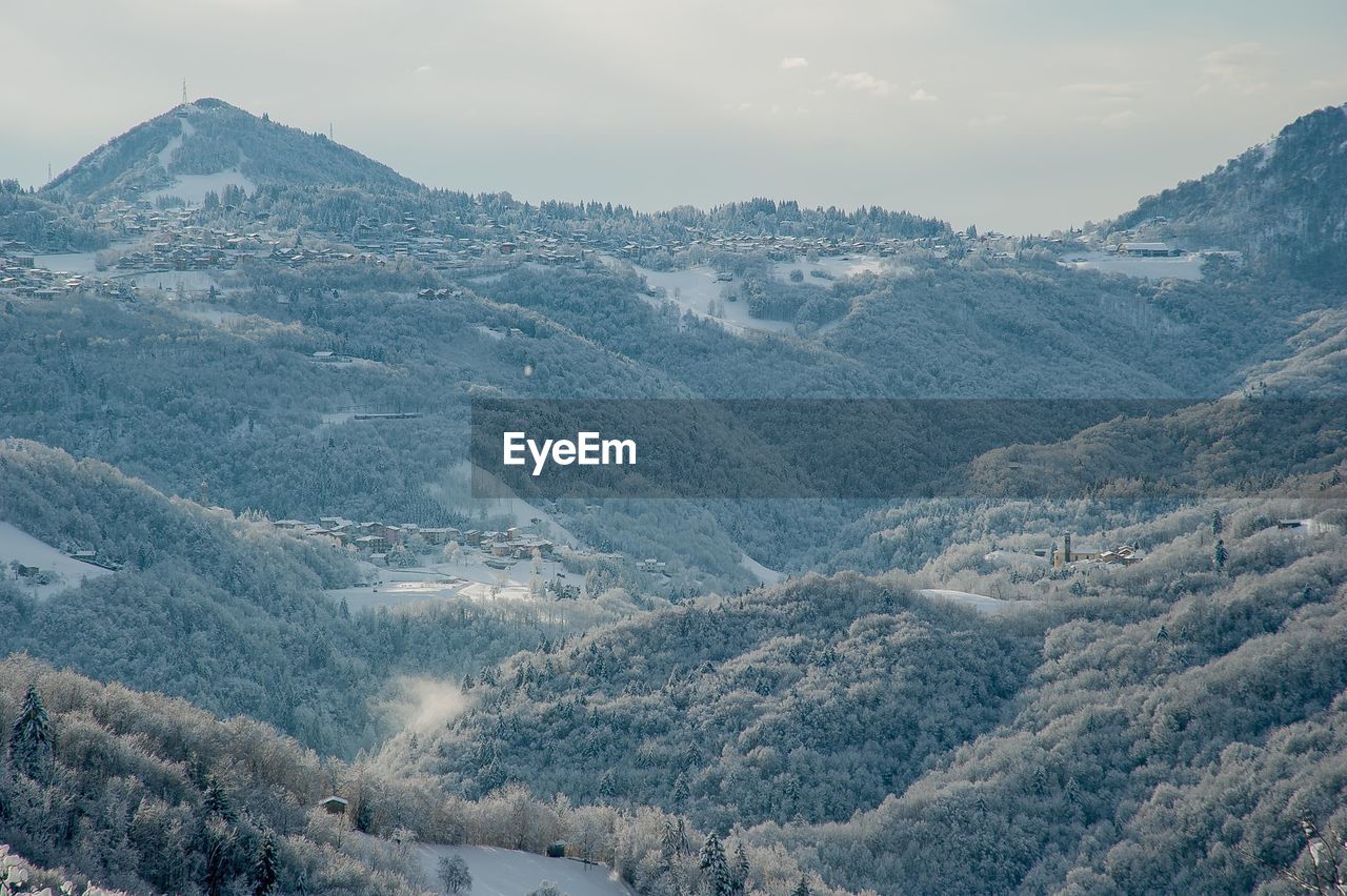 Aerial view of snowcapped mountains against sky