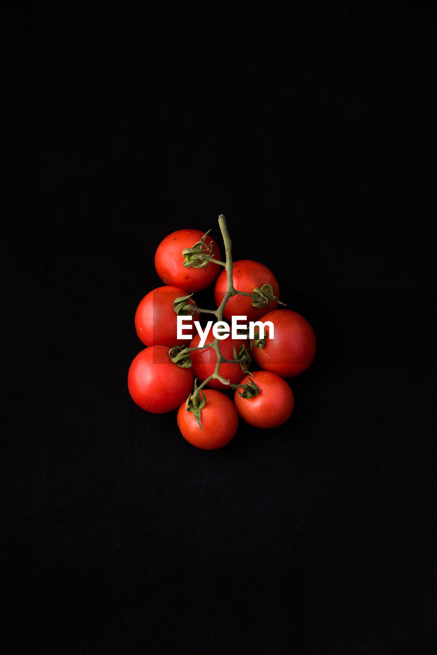 Close-up of cherry tomatoes against black background