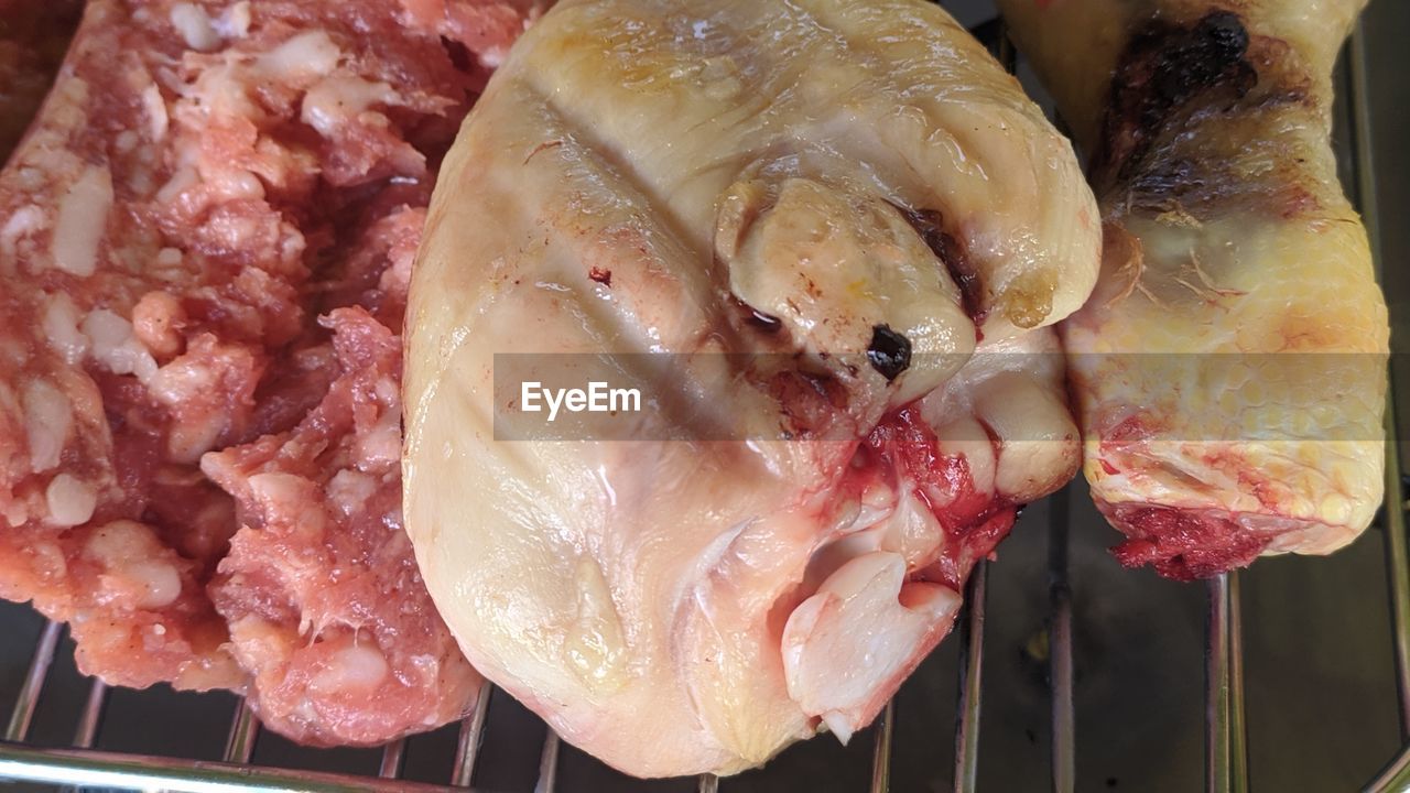 HIGH ANGLE VIEW OF MEAT COOKING ON BARBECUE